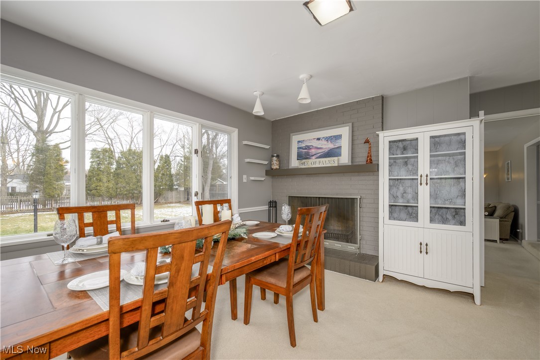 1989 Larchmont Road Akron, OH 44313 - Photo 12 of 38 Dining area featuring a brick fireplace and light colored carpet