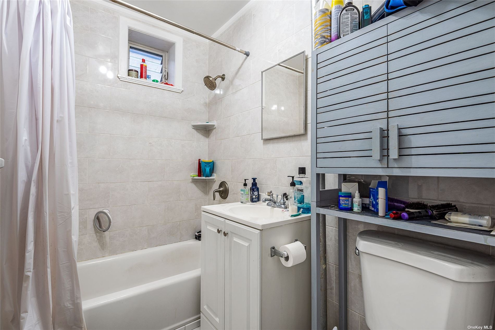 37-68 64th Street Queens, NY 11377 - Photo 12 of 12 a bathroom with a sink a toilet and shower