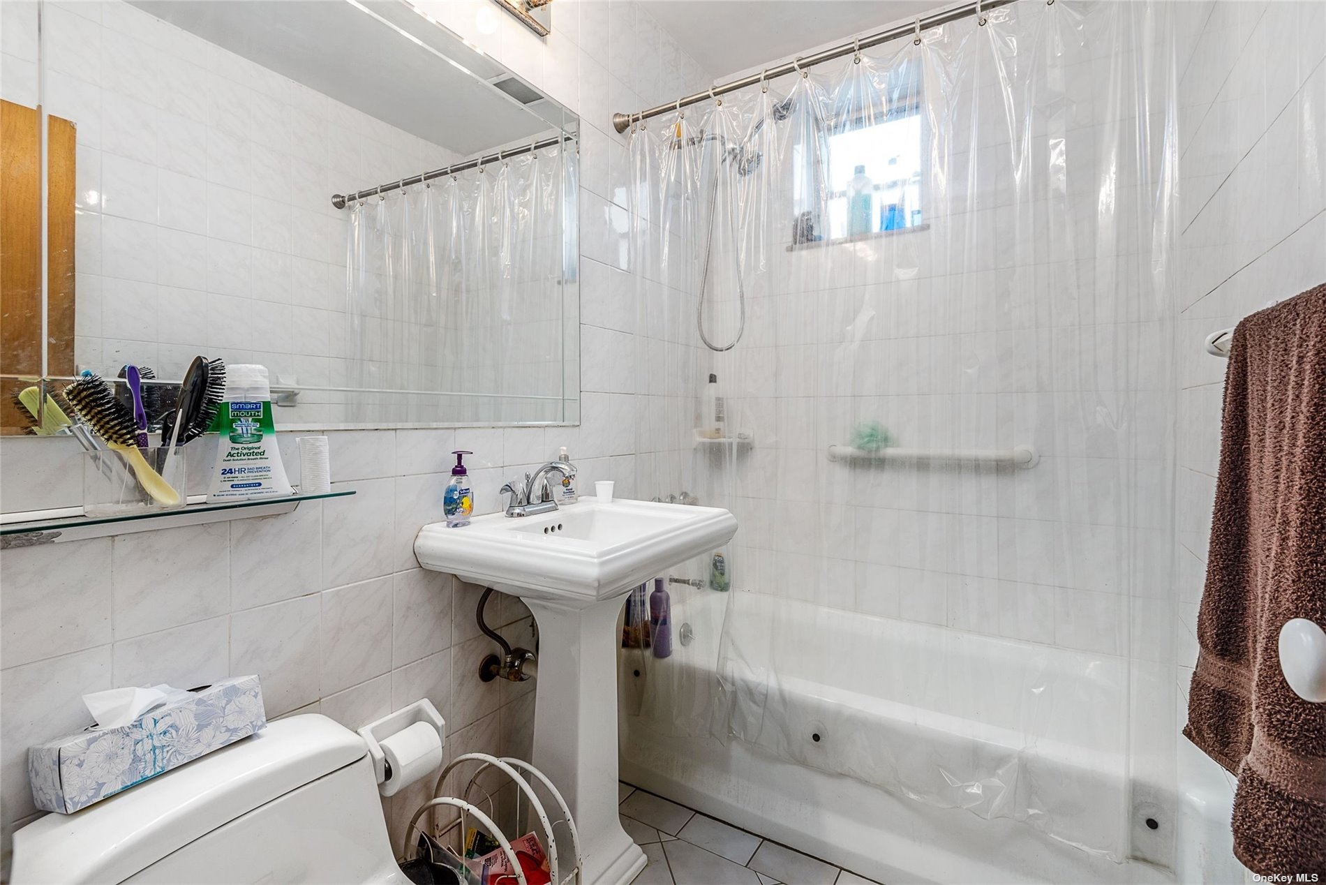 37-68 64th Street Queens, NY 11377 - Photo 6 of 12 a bathroom with a sink a toilet and shower