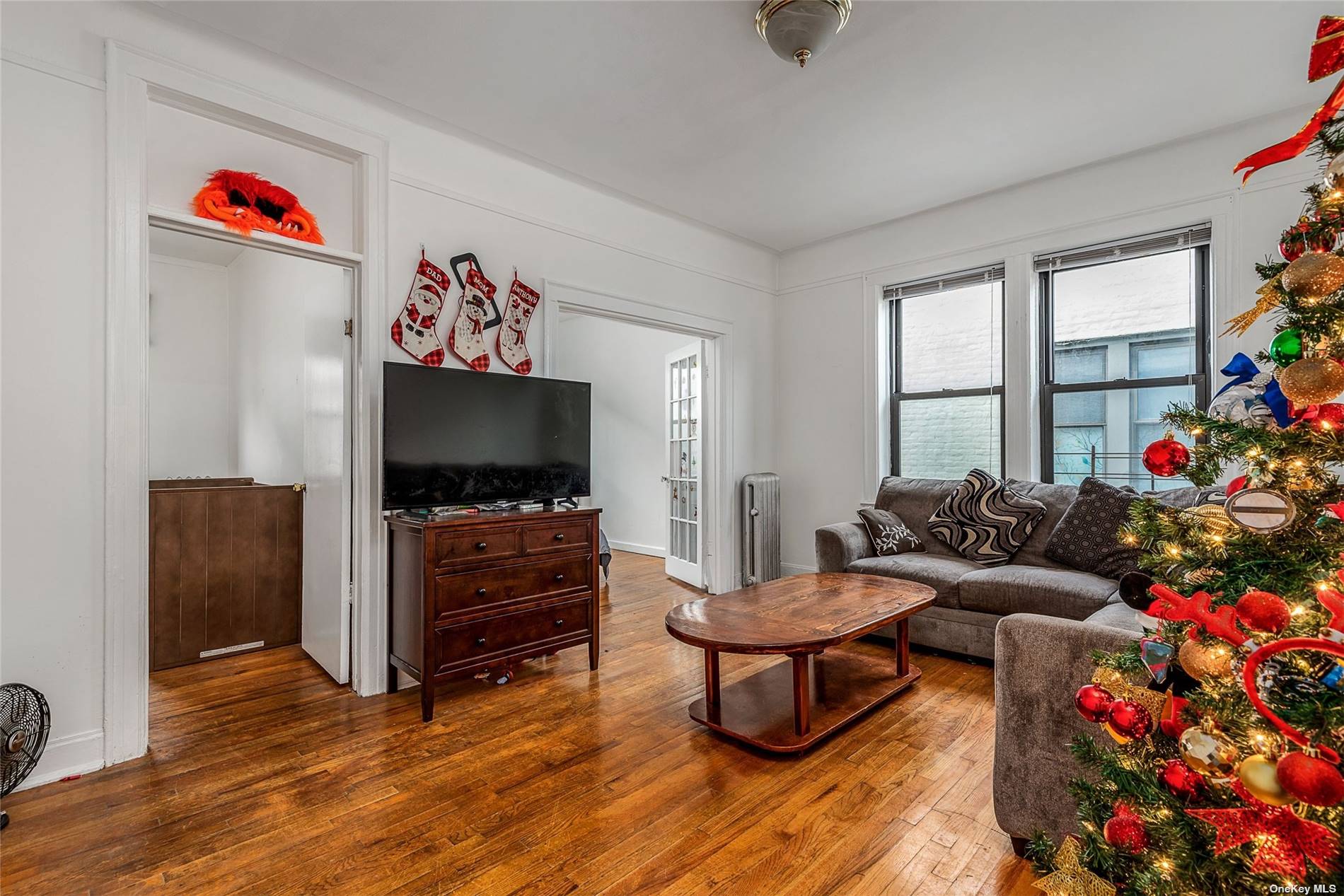 37-68 64th Street Queens, NY 11377 - Photo 7 of 12 a living room with furniture and a flat screen tv