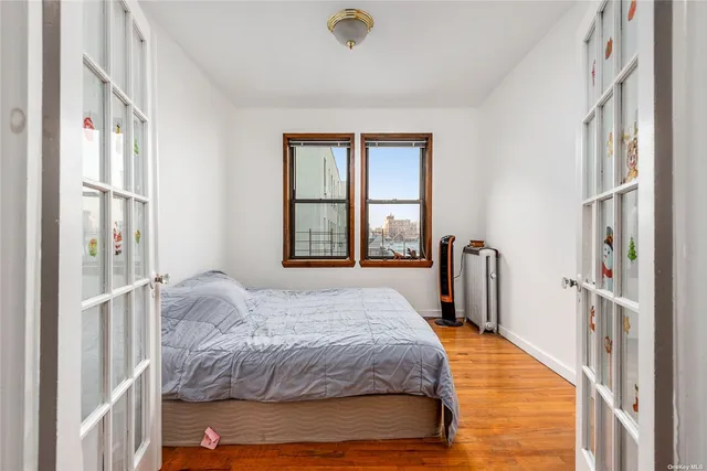 a bedroom with a bed closet and a large window