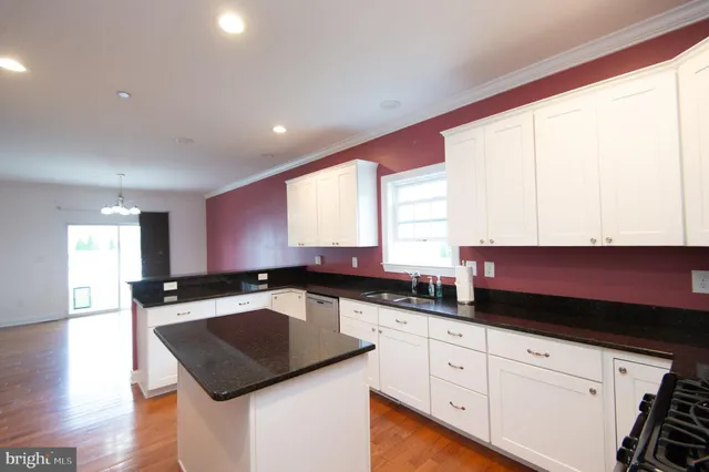 a view of a storage room with racks shoes and a rug