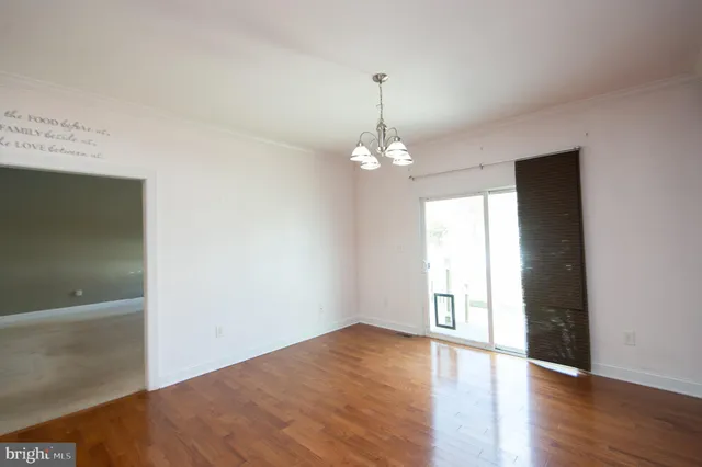 a view of an entryway with wooden floor