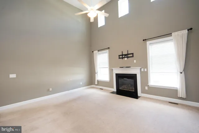 a view of a room with a ceiling fan and a window