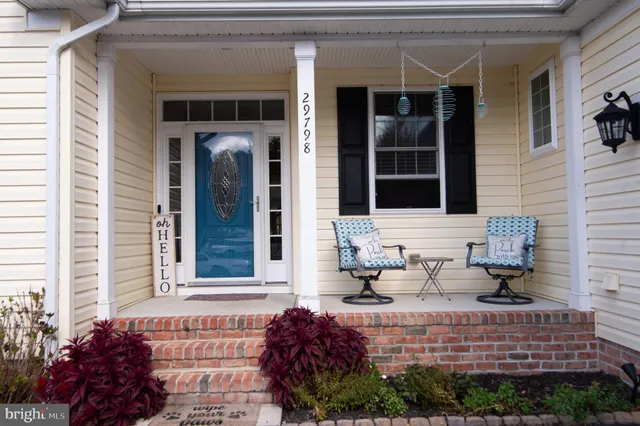 a view of a hallway with wooden floor and entryway