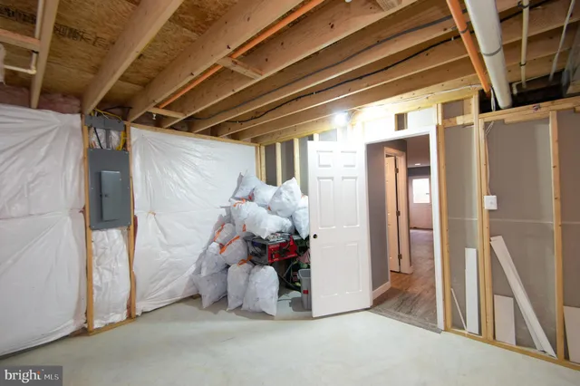 an empty room with window and ceiling fan