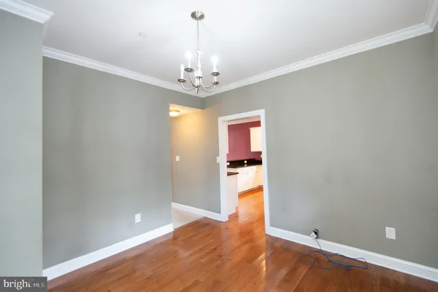 a kitchen with stainless steel appliances kitchen island granite countertop a sink a stove top oven a counter space and cabinets