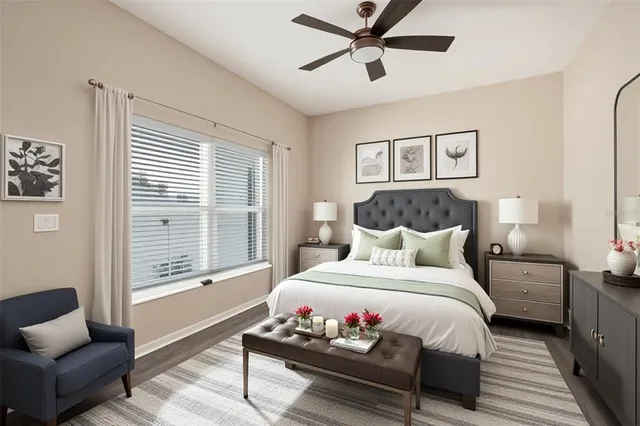 an empty room with wooden floor and ceiling fan