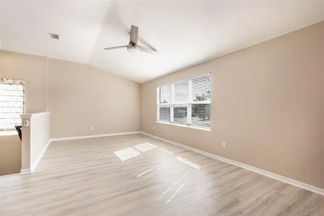 a living room with furniture a flat screen tv and a large window