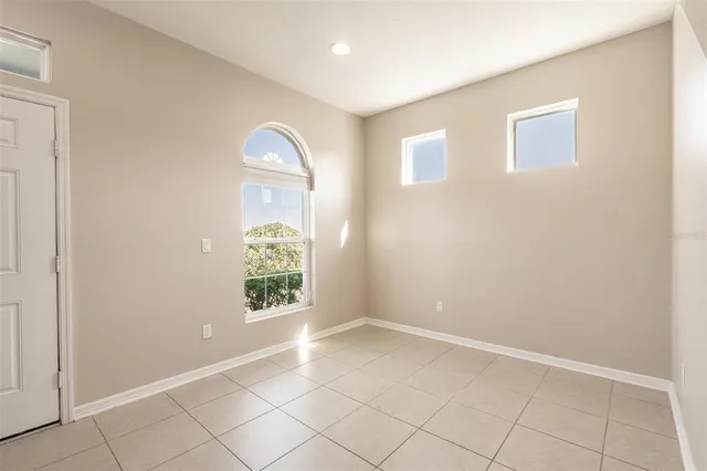 a kitchen with granite countertop a refrigerator and a stove top oven