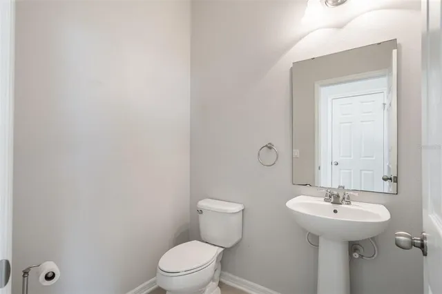 a kitchen with stainless steel appliances granite countertop a stove top oven a sink and a refrigerator