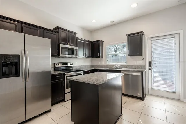 a kitchen with stainless steel appliances granite countertop a sink stove and oven