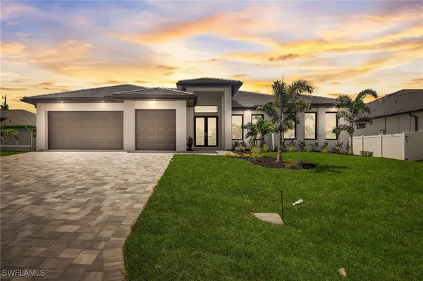 a front view of a house with a yard and garage