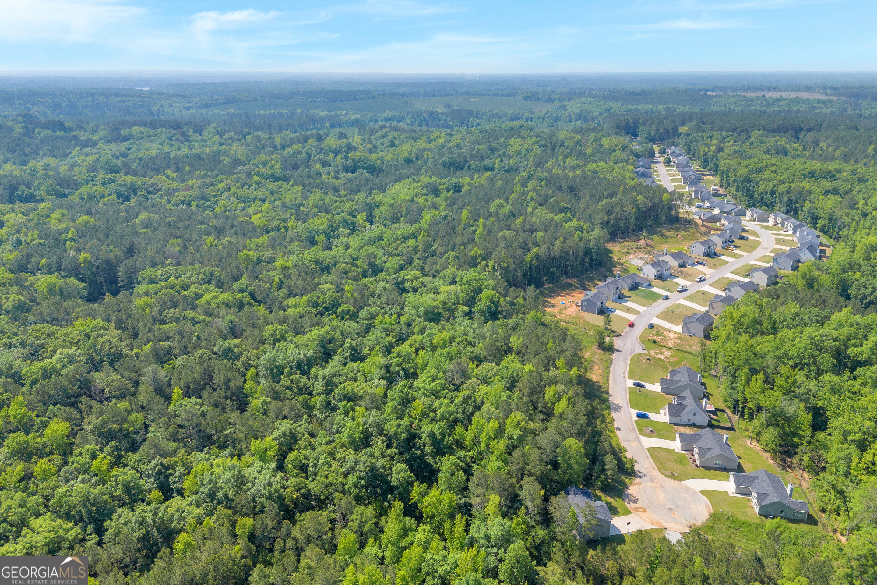 0 Harmony Road, Unit 1 Eatonton, GA 31024 - Photo 13 of 15 an aerial view of residential houses with outdoor space and trees