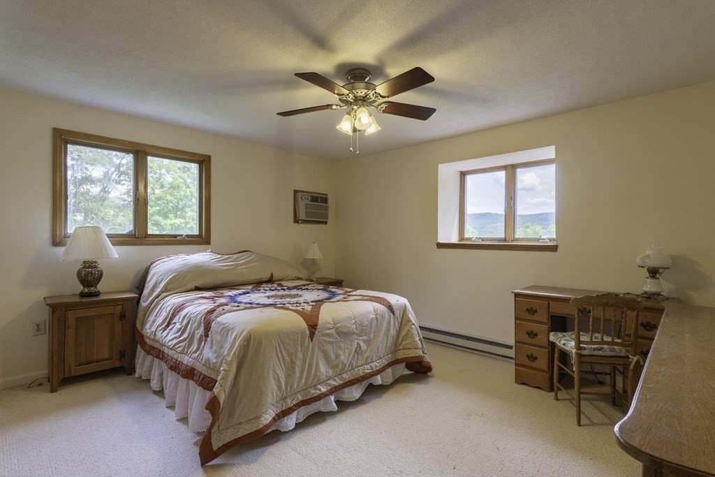 735 North Poland Road Conway, MA 01341 - Photo 14 of 40 a bedroom with a bed and a chandelier