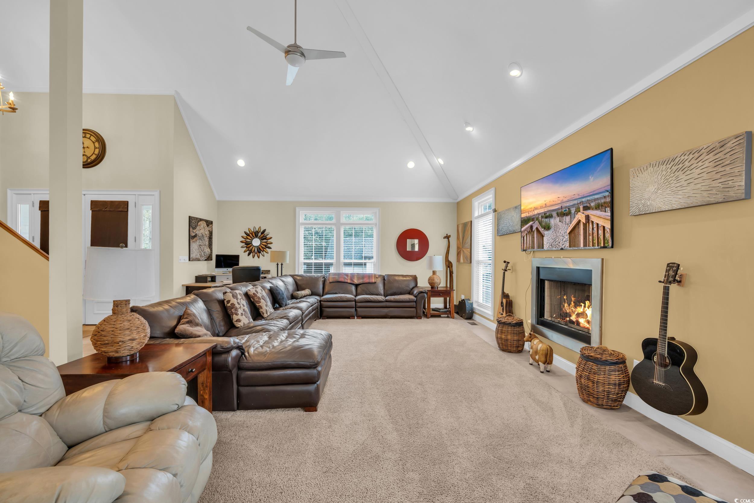 830 Channel Cat Cove Murrells Inlet, SC 29576 - Photo 3 of 40 Living room with crown molding, high vaulted ceiling, ceiling fan, and carpet flooring
