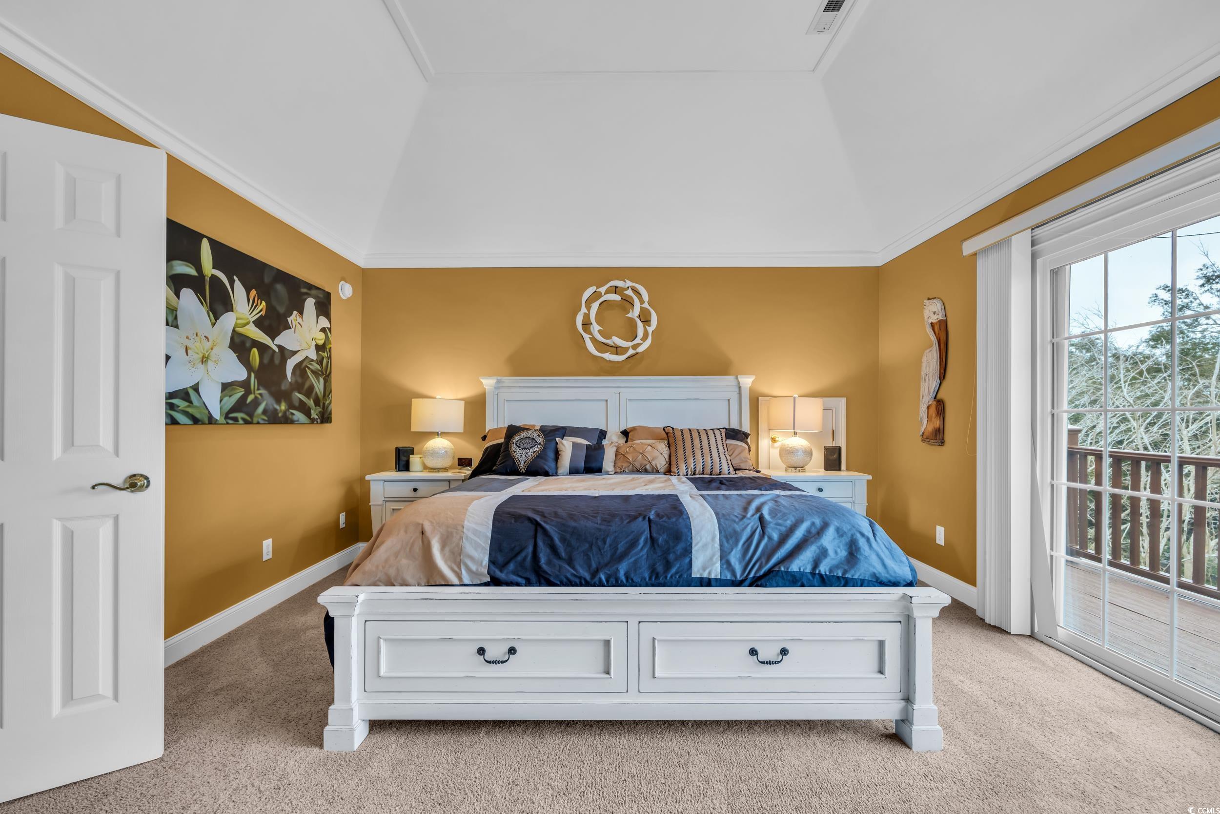 830 Channel Cat Cove Murrells Inlet, SC 29576 - Photo 5 of 40 Bedroom with light colored carpet, vaulted ceiling, multiple windows, and access to outside