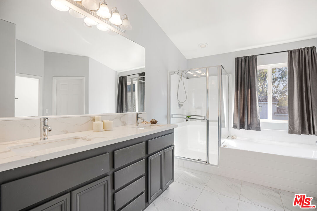 18404 Arminta Street Reseda, CA 91335 - Photo 11 of 13 a bathroom with a double vanity sink a mirror and a shower