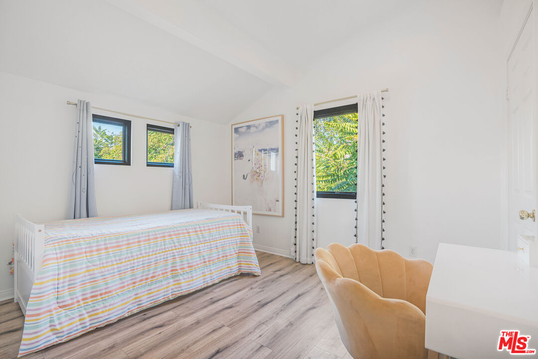 18404 Arminta Street Reseda, CA 91335 - Photo 12 of 13 a bedroom with furniture and a window