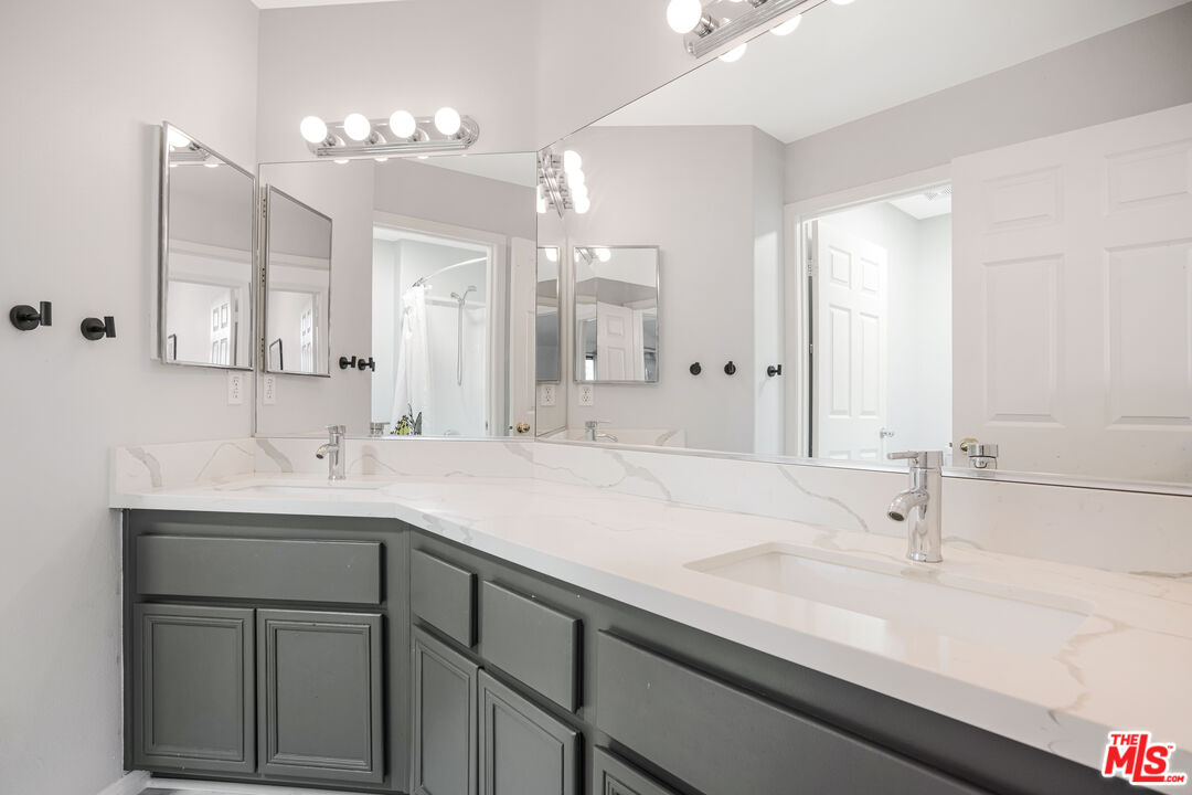 18404 Arminta Street Reseda, CA 91335 - Photo 13 of 13 a bathroom with a sink double vanity and a mirror