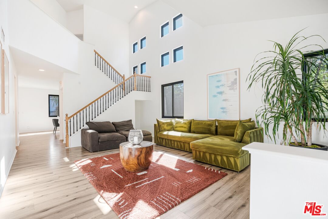 18404 Arminta Street Reseda, CA 91335 - Photo 3 of 13 a living room with furniture and a rug