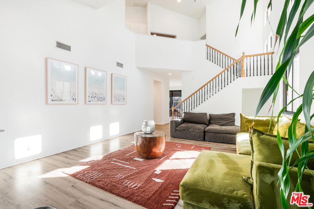 18404 Arminta Street Reseda, CA 91335 - Photo 4 of 13 a living room with furniture and wooden floor