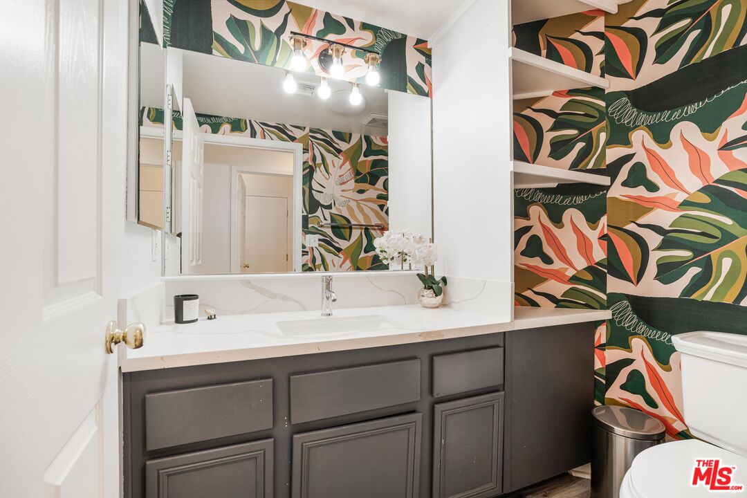 18404 Arminta Street Reseda, CA 91335 - Photo 9 of 13 a bathroom with a sink and a mirror