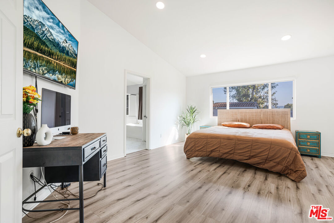 18404 Arminta Street Reseda, CA 91335 - Photo 10 of 13 a bedroom with a bed and a table