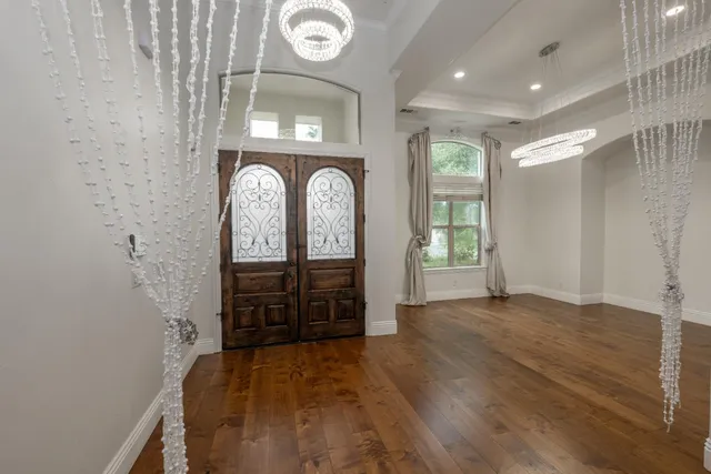 a view of a hallway with entryway wooden floor and front door