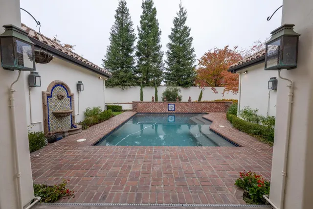 a view of a swimming pool with a yard