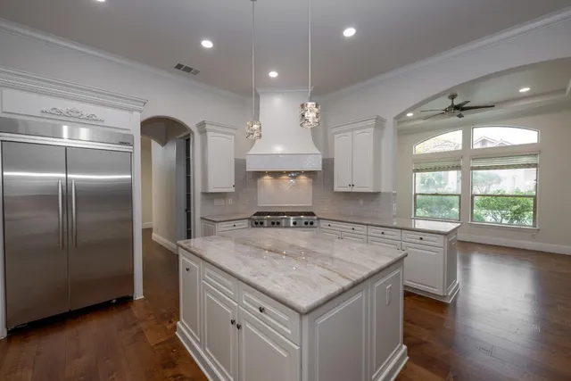 a kitchen with a stove a refrigerator and a sink