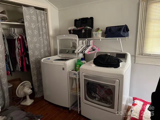 a kitchen with a stove and a flat screen tv