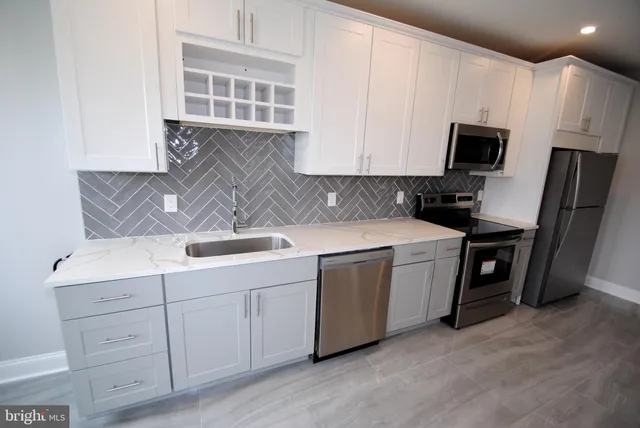 a kitchen with a sink stove and cabinets