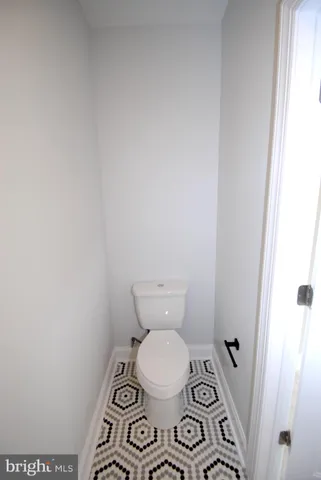 a white toilet sitting next to a shower
