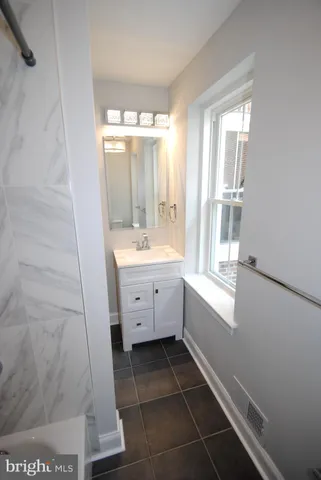 a bathroom with a double vanity sink a toilet and a mirror