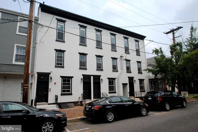 a couple of cars parked in front of a building