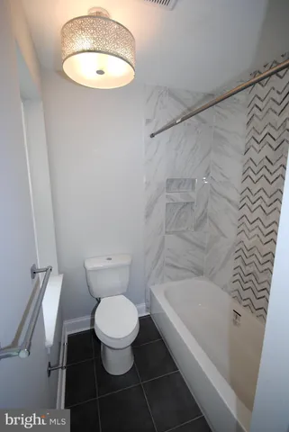 a bathroom with a toilet and a bathtub