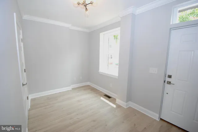 an empty room with windows and closet
