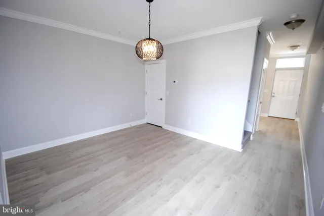 a view of a room with wooden floor and a window
