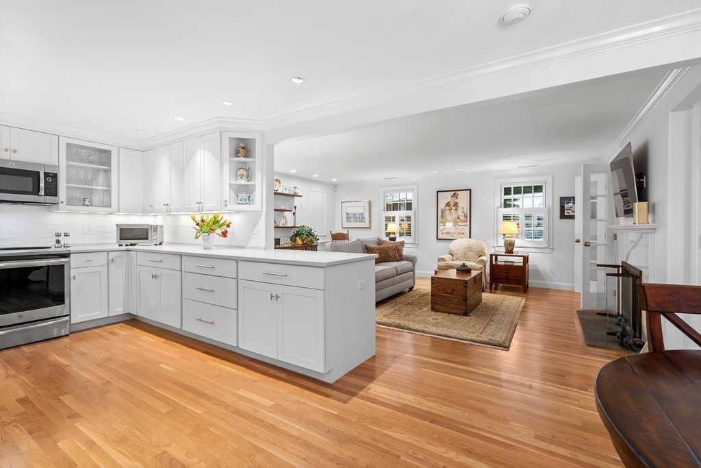 85 Jericho Road, Unit 85 Weston, MA 02493 - Photo 4 of 17 a large white open kitchen with white cabinets and stainless steel appliances