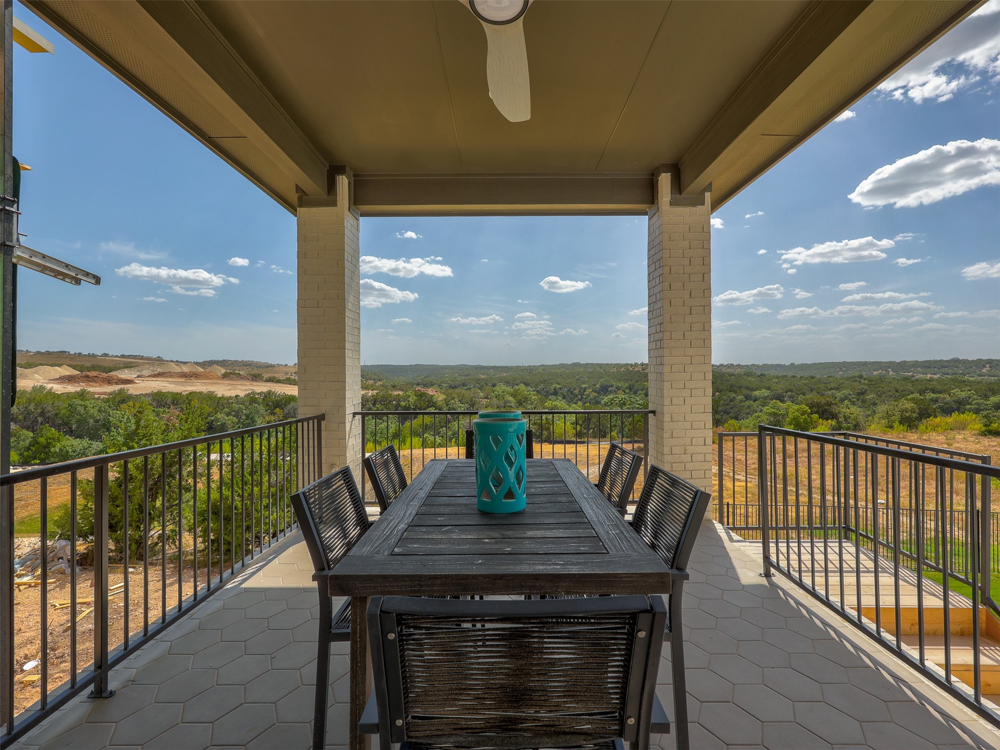 6220 Bower Well Road Austin, TX 78738 - Photo 2 of 28 An inviting covered patio offers panoramic views of the surrounding natural landscape.