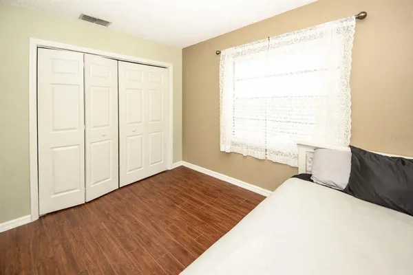 a bedroom with a bed and a window