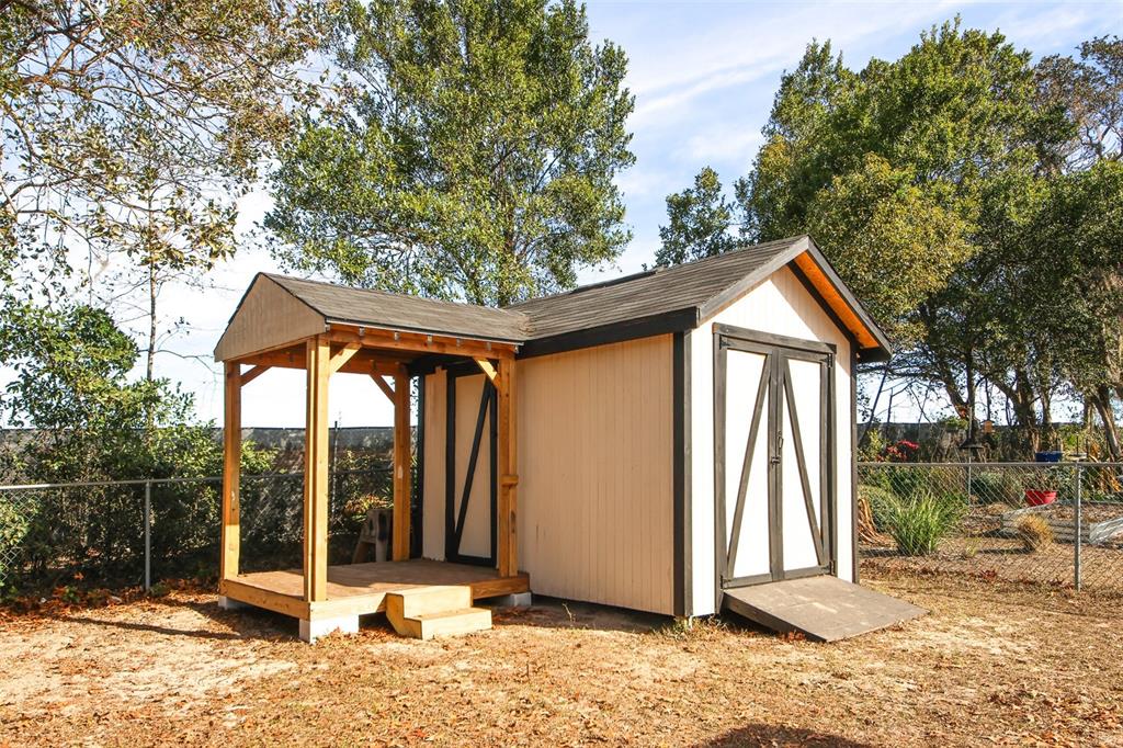 13277 Delbarton Street Spring Hill, FL 34609 - Photo 20 of 22 a front view of a house with garden