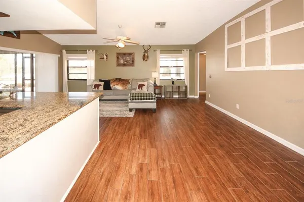 a living room with furniture and wooden floor