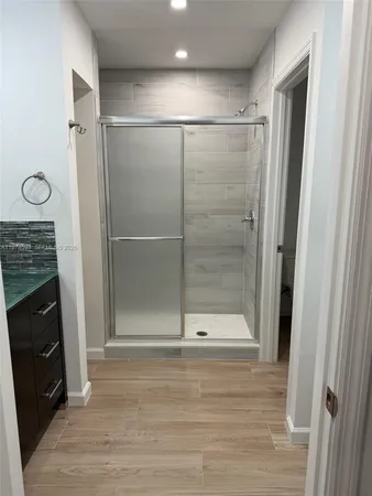 a bathroom with a shower and a mirror
