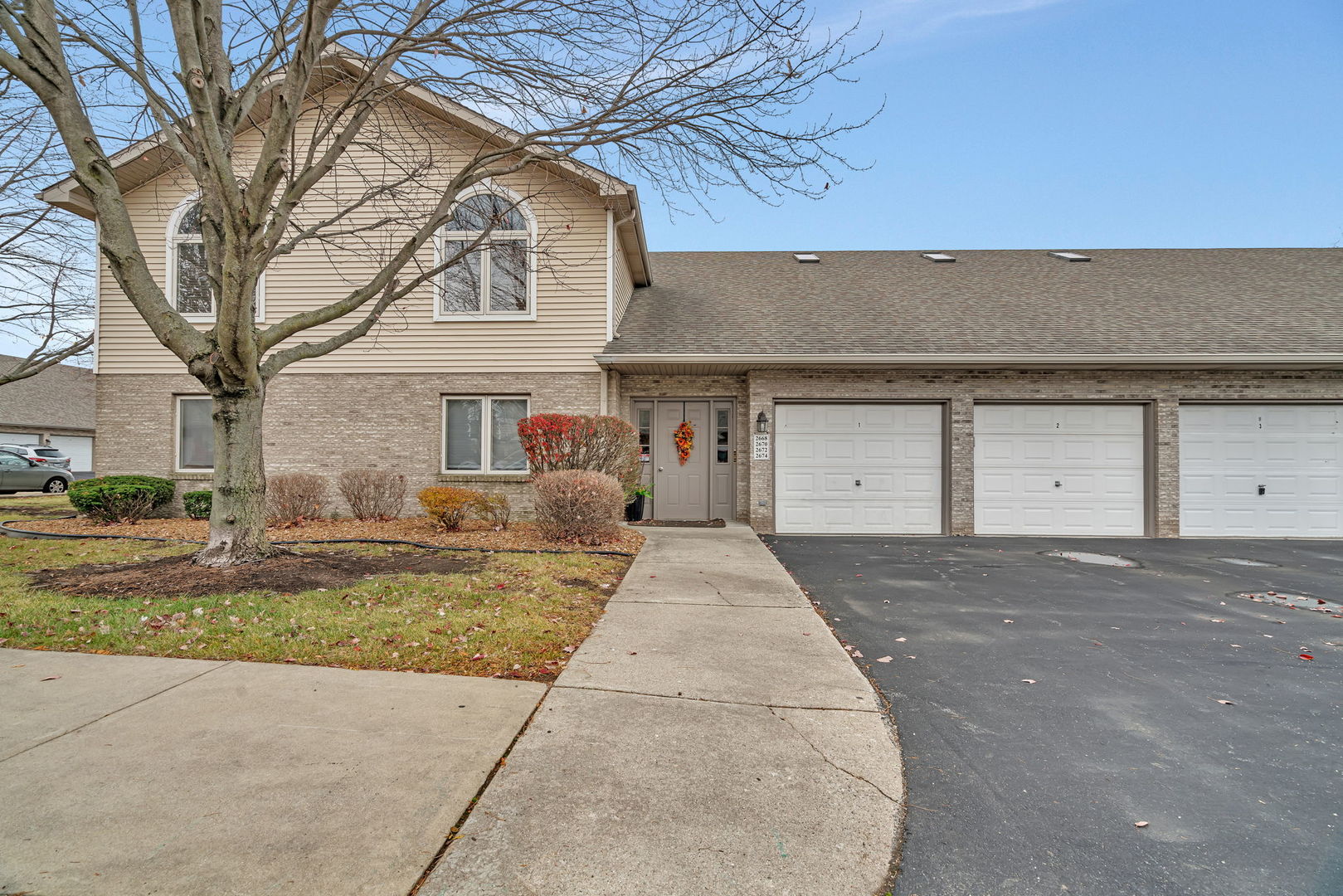 a front view of a house with a yard and garage