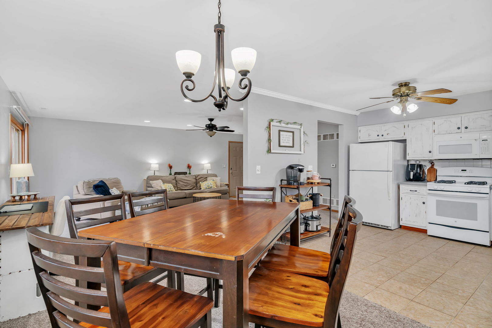 2670 Jodee Drive, Unit B Joliet, IL 60436 - Photo 8 of 23 a view of a dining room and livingroom with furniture wooden floor a chandelier