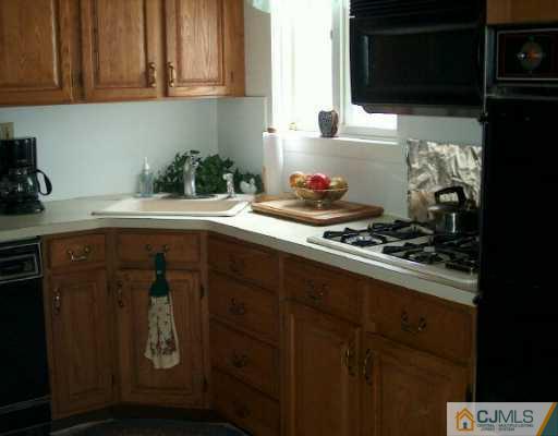 12 Finley Road Edison, NJ 08817 - Photo 3 of 8 a kitchen with a sink and cabinets
