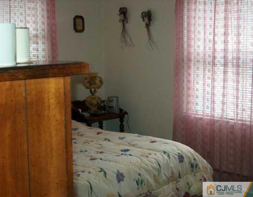 12 Finley Road Edison, NJ 08817 - Photo 8 of 8 a bedroom with a bed and a window