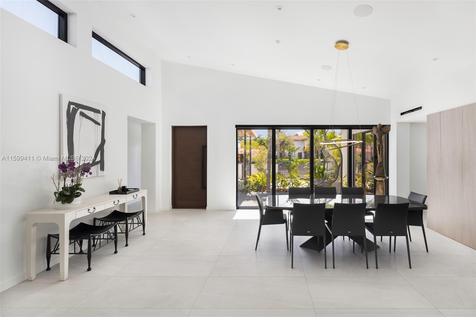 5225 La Gorce Drive Miami Beach, FL 33140 - Photo 12 of 64 a view of a dining room with furniture and chandelier